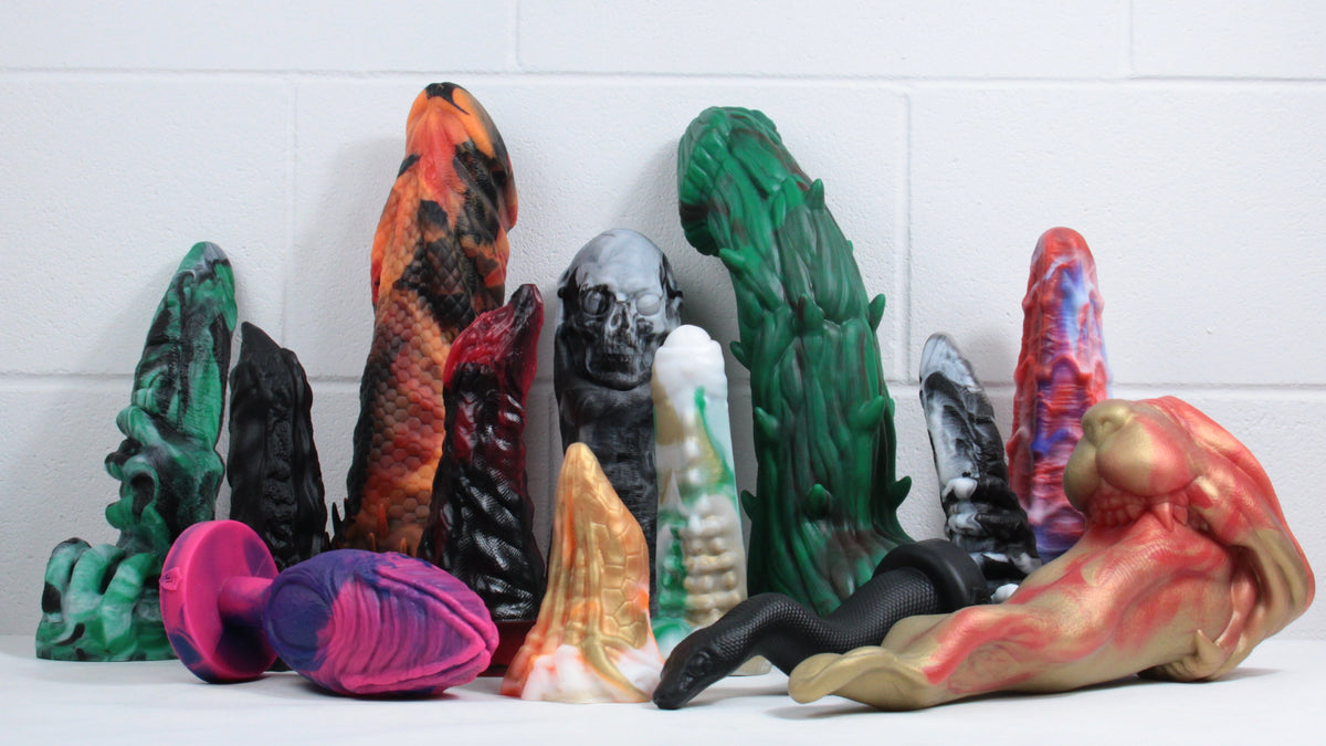 Collection of Halloween-themed toys. Left to right: omen, diablo's finger, barbarian, john's dragon, graveyard ghoul, predator, woody, omen, spidey's web. At the front: alien egg, the peak, the snake, beast of bodmin.