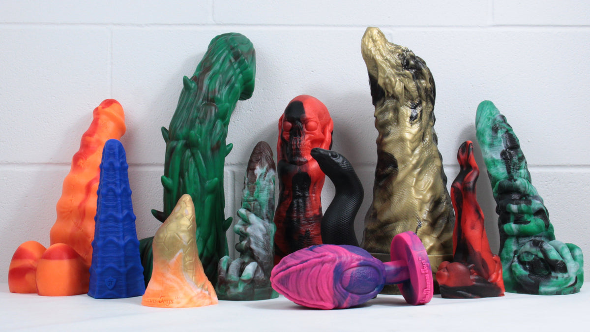 Collection of Halloween-themed toys. Left to right: monster, spidey's web, woody, omen, graveyard ghoul, snake, John's dragon, beast of bodmin, omen. At the front: the peak, alien egg.