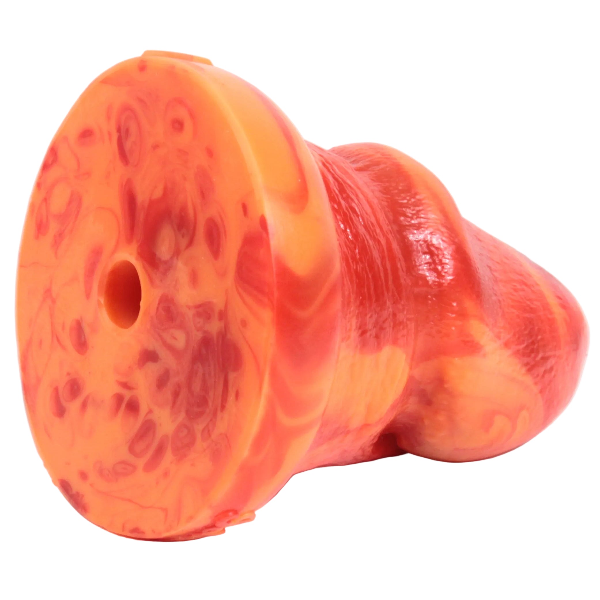 Bell End in Desire (orange and red fusion), on its side, facing away and showing the vac-u-lock compatible hole. Each Bell End is compatible with vac-u-lock products.